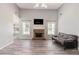 Spacious living room featuring a brick fireplace, vaulted ceiling, and wood-look floors at 1478 Elena Dr, Mcdonough, GA 30253