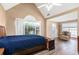 Main bedroom features a vaulted ceiling, ceiling fan, and large windows at 1478 Elena Dr, Mcdonough, GA 30253