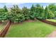 Large, grassy backyard enclosed by a wooden fence and mature trees at 216 Orchard Trl, Canton, GA 30115