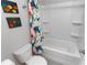 Full bathroom with a tub, toilet, Dinosaur themed decorations, and light gray paint at 216 Orchard Trl, Canton, GA 30115