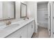 Bright bathroom with double sinks, white cabinets, silver hardware and access to the shower and toilet at 216 Orchard Trl, Canton, GA 30115