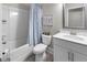 Bathroom with tub and shower, white vanity, framed mirror, and calming decor at 216 Orchard Trl, Canton, GA 30115