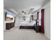 Large primary bedroom with a tray ceiling, tv, en-suite bathroom, and a large window for natural light at 216 Orchard Trl, Canton, GA 30115