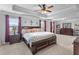 The primary bedroom offers a tray ceiling, a king bed, and plenty of space for storage at 216 Orchard Trl, Canton, GA 30115