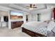 Primary bedroom featuring a tray ceiling, tv, en-suite bathroom, and a large walk-in closet at 216 Orchard Trl, Canton, GA 30115