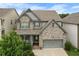 Charming two-story home with a well-manicured lawn and a two-car garage at 216 Orchard Trl, Canton, GA 30115