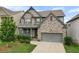 Charming two-story home with a well-manicured lawn and a two-car garage at 216 Orchard Trl, Canton, GA 30115