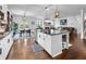 Open-concept kitchen with island, granite countertops, stainless appliances, and seamless flow to dining and living areas at 216 Orchard Trl, Canton, GA 30115