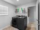 Bright laundry room with front load washer and dryer and a shelf for storage at 216 Orchard Trl, Canton, GA 30115