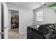 Well lit laundry room connected to the walk-in closet and a front load washer and dryer at 216 Orchard Trl, Canton, GA 30115