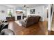 Open-concept living room with a fireplace, hardwood floors, and comfortable seating at 216 Orchard Trl, Canton, GA 30115