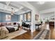 Open-concept living room with hardwood floors, stylish furniture, and ample natural light at 216 Orchard Trl, Canton, GA 30115