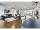 Open-concept layout showcases kitchen, living, and dining areas with hardwood floors and neutral decor at 216 Orchard Trl, Canton, GA 30115