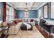 Comfortable living room with a large sectional sofa and coffered ceiling, creating a cozy atmosphere at 216 Orchard Trl, Canton, GA 30115