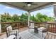 Relaxing outdoor deck with ceiling fan, stylish seating, and views of lush greenery at 216 Orchard Trl, Canton, GA 30115