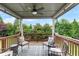 Inviting deck area with ceiling fan and plush seating overlooking a beautiful wooded backyard at 216 Orchard Trl, Canton, GA 30115
