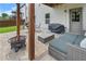 Cozy stone patio with a fireplace, grill, and comfortable seating for outdoor entertaining at 216 Orchard Trl, Canton, GA 30115