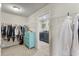 Walk-in closet with wire shelving and open access to the laundry room with washer and dryer at 216 Orchard Trl, Canton, GA 30115