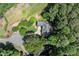 Expansive aerial view of home nestled among mature trees in established neighborhood on a large manicured lot at 3600 Goldenrod Dr, Alpharetta, GA 30005