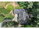 An aerial view shows the roofline of the home, driveway, and surrounding, mature trees at 3600 Goldenrod Dr, Alpharetta, GA 30005