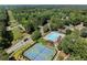 Aerial view of the community pool and tennis courts surrounded by trees at 3600 Goldenrod Dr, Alpharetta, GA 30005