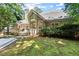 A beautiful backyard featuring a spacious patio, well-manicured lawn, and lush landscaping with a view of the home's exterior at 3600 Goldenrod Dr, Alpharetta, GA 30005