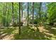 A secluded and private backyard with mature trees surrounds this home, offering a sense of calm in a park-like setting at 3600 Goldenrod Dr, Alpharetta, GA 30005