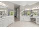 Large bathroom with dual sinks, ample counter space, a vanity area, and multiple mirrors for a luxurious feel at 3600 Goldenrod Dr, Alpharetta, GA 30005