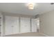 Neutral bedroom featuring double closets and a modern lighting fixture at 3600 Goldenrod Dr, Alpharetta, GA 30005