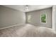 Spacious bedroom with neutral walls, carpeted floors, and natural light from windows at 3600 Goldenrod Dr, Alpharetta, GA 30005