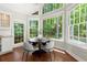 Sunlit breakfast nook featuring large windows with view and stylish table and chairs at 3600 Goldenrod Dr, Alpharetta, GA 30005
