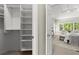 Bright walk-in closet featuring built-in shelving and storage solutions, seamlessly connecting to the bedroom area at 3600 Goldenrod Dr, Alpharetta, GA 30005