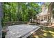 The home boasts a spacious wooden deck with built in seating, great for outdoor enjoyment and surrounded by mature trees at 3600 Goldenrod Dr, Alpharetta, GA 30005