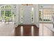 Sunlit foyer with hardwood floors flanked by formal spaces with large windows offering scenic views at 3600 Goldenrod Dr, Alpharetta, GA 30005