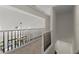 Hallway with black and white railings overlooking the chandelier and the living area at 3600 Goldenrod Dr, Alpharetta, GA 30005