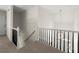 Second floor hallway features white and black railings, carpeted floors, and a hanging chandelier at 3600 Goldenrod Dr, Alpharetta, GA 30005