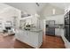 Open kitchen featuring a large island, stainless steel appliances, and hardwood floors at 3600 Goldenrod Dr, Alpharetta, GA 30005