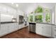 Well-lit kitchen showcasing white cabinets, stainless steel appliances, and a view of the outdoors at 3600 Goldenrod Dr, Alpharetta, GA 30005