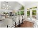 Bright kitchen with bar seating, granite countertops, stainless steel appliances and access to the deck at 3600 Goldenrod Dr, Alpharetta, GA 30005