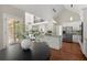 Spacious kitchen with stainless steel appliances, island with seating, and view into the living area at 3600 Goldenrod Dr, Alpharetta, GA 30005