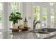 Close up of a kitchen counter with granite countertops and a stainless steel sink at 3600 Goldenrod Dr, Alpharetta, GA 30005