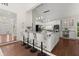 Open kitchen with granite countertops, bar seating, stainless steel appliances, and hardwood flooring at 3600 Goldenrod Dr, Alpharetta, GA 30005