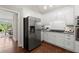 Modern kitchen featuring stainless steel appliances, white cabinetry, and hardwood floors at 3600 Goldenrod Dr, Alpharetta, GA 30005