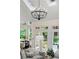 Living room with skylights, chandelier, french doors with outdoor views, and comfortable seating at 3600 Goldenrod Dr, Alpharetta, GA 30005