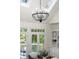 Bright living room with skylights, chandelier, and french doors leading to an outdoor space at 3600 Goldenrod Dr, Alpharetta, GA 30005