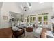 Bright, open living room with stone fireplace, hardwood floors, skylights and access to the outdoor deck at 3600 Goldenrod Dr, Alpharetta, GA 30005