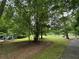 Outdoor playground with slides and a seating area visible from a paved trail in a lush community at 3600 Goldenrod Dr, Alpharetta, GA 30005