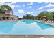 Large community pool with lounge chairs and lifeguard stand under a bright, cloudy sky at 3600 Goldenrod Dr, Alpharetta, GA 30005