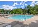 Community pool with lounge seating and umbrellas at 3600 Goldenrod Dr, Alpharetta, GA 30005