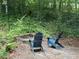 Inviting backyard firepit area with comfortable Adirondack chairs, perfect for relaxing evenings outdoors at 507 Spring Creek Ne Way, Marietta, GA 30068
